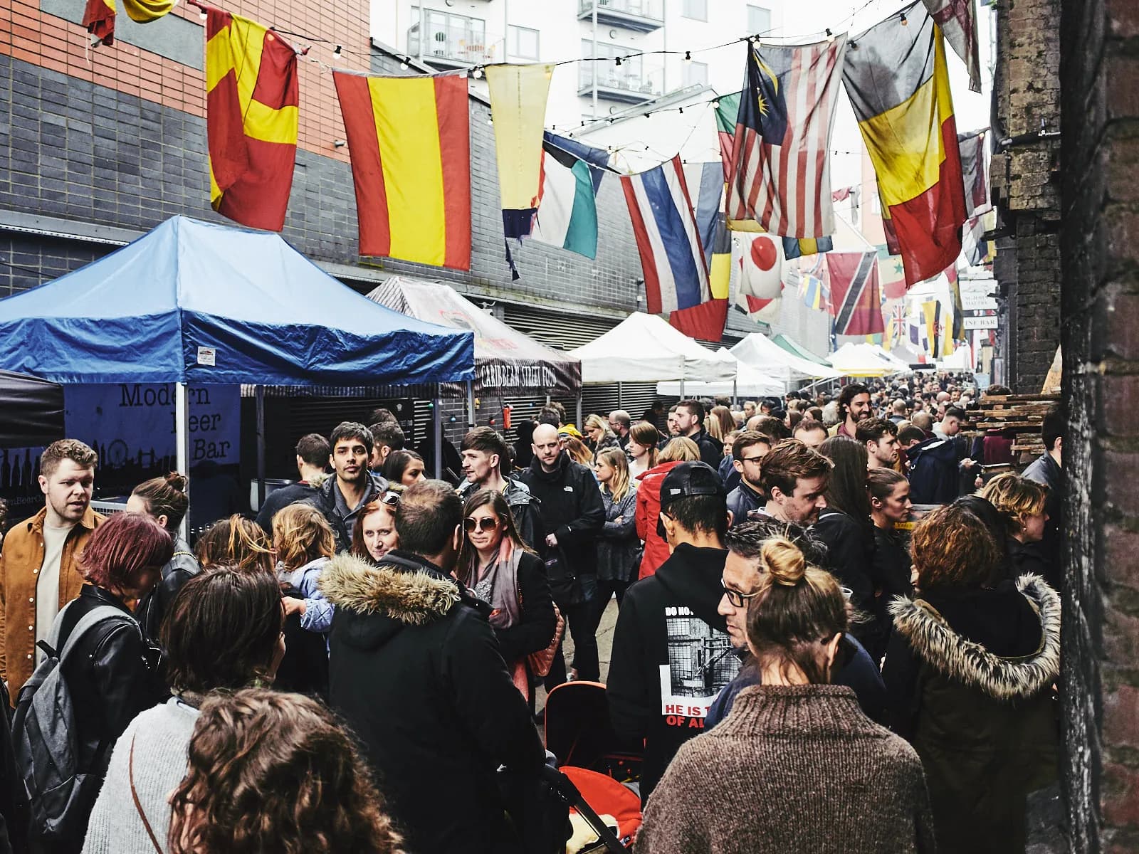 Tables sous les guirlandes de fanions et les tentes du Ropewalk, le Maltby Street Market à Bermondsey